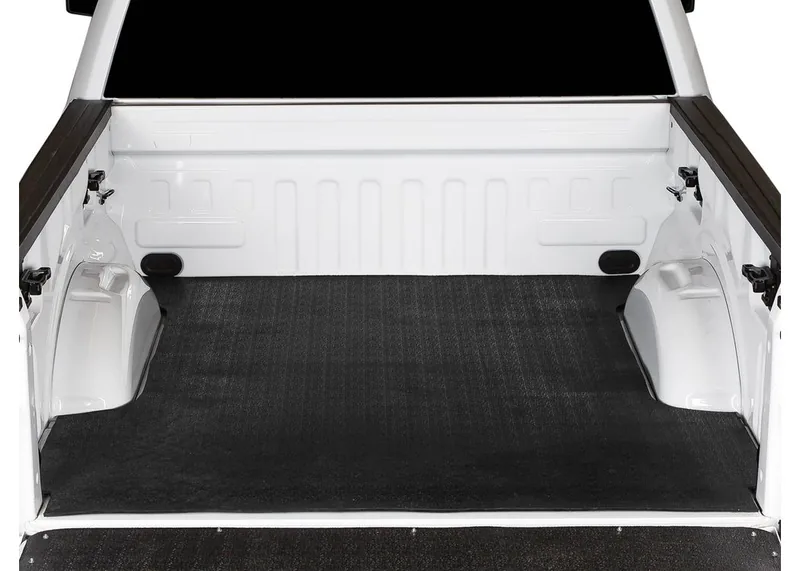Heavy-duty rubber bed mat over a spray-on bedliner in a pickup truck bed